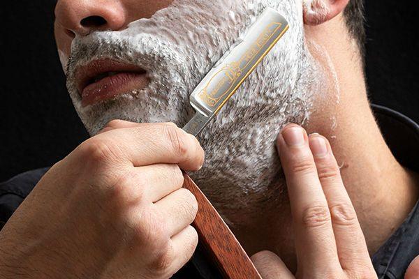Men shaving with Dovo straight razor