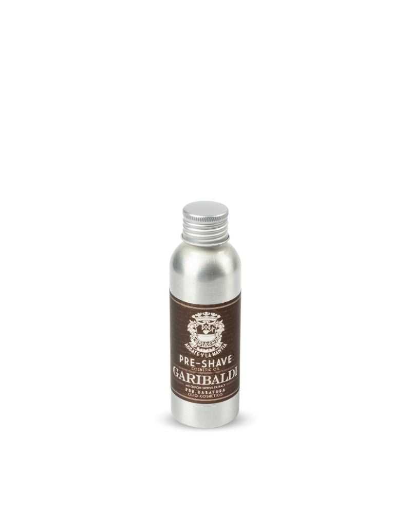 A bottle of 'Abbate y La Mantia - Garibaldi Pre-Shave Oil' with a label that has an image of a bearded man and the product name. The bottle is metallic and has a white cap.