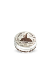 A round tin container with a label featuring an illustration of a man's face, titled 'Garibaldi' and indicating it is a hard shaving soap.