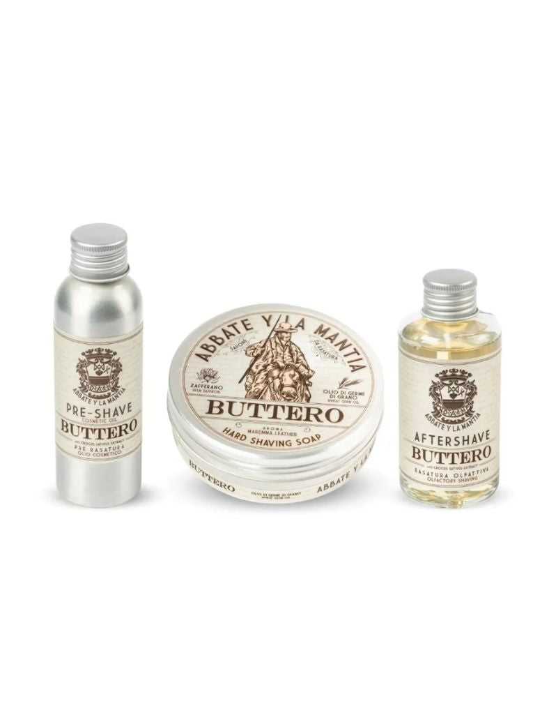 The image shows three products from the Shaving Routine Buttero set: a tin container of shaving butter, a bottle of pre-shave oil, and a bottle of aftershave lotion, all labeled and arranged neatly.