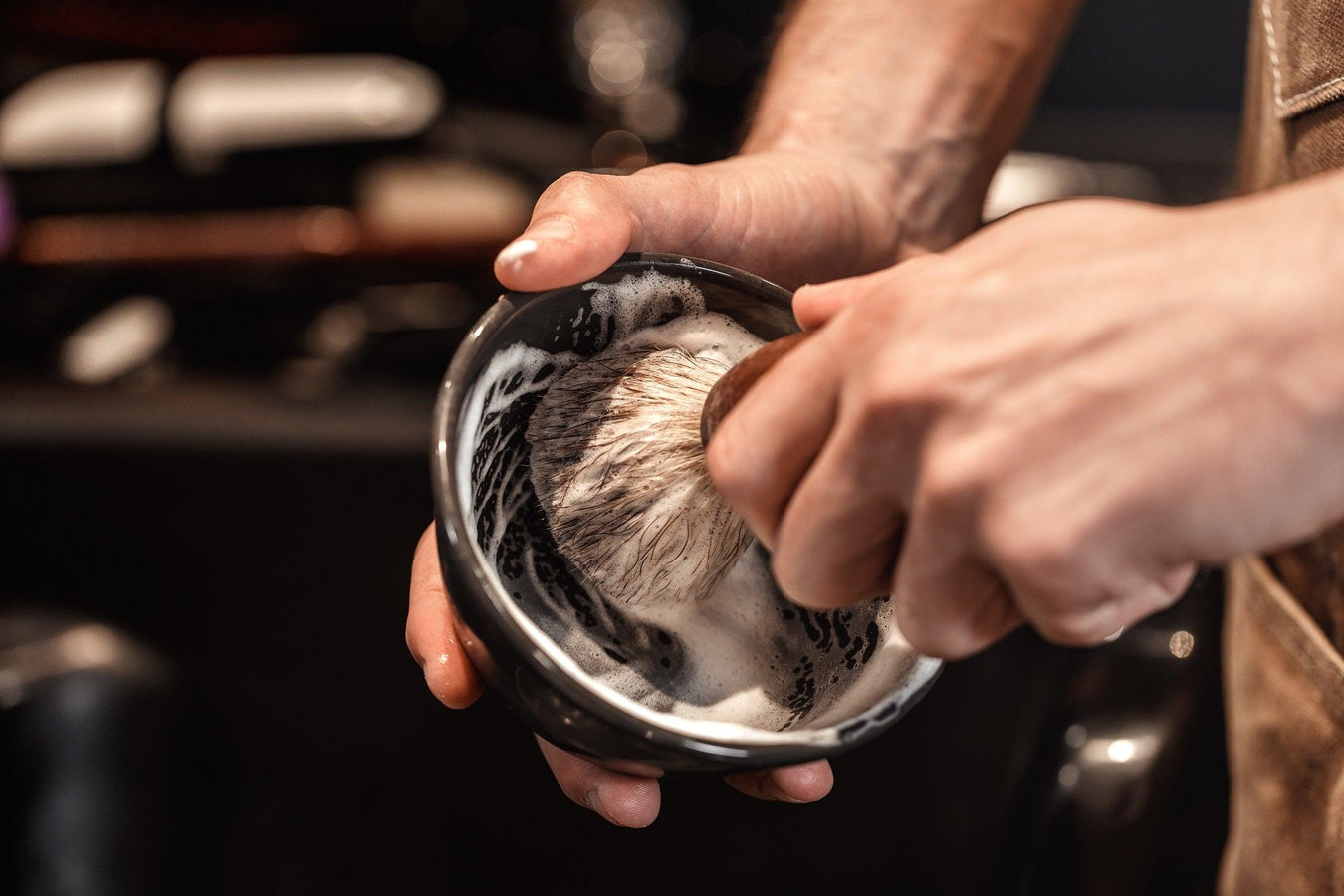 Men lathering shaving soap in metal bowl