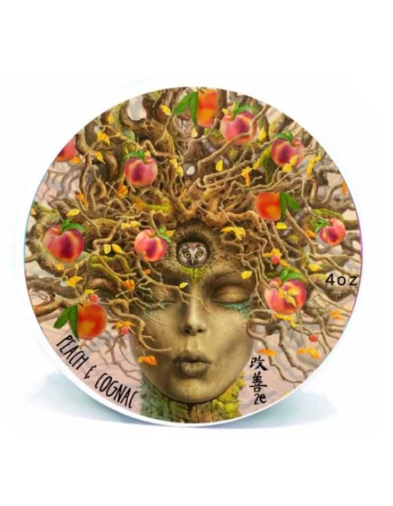 Decorative bottle cap with artistic design of a face and fruit, featuring the brand 'Peach & Cognac'.