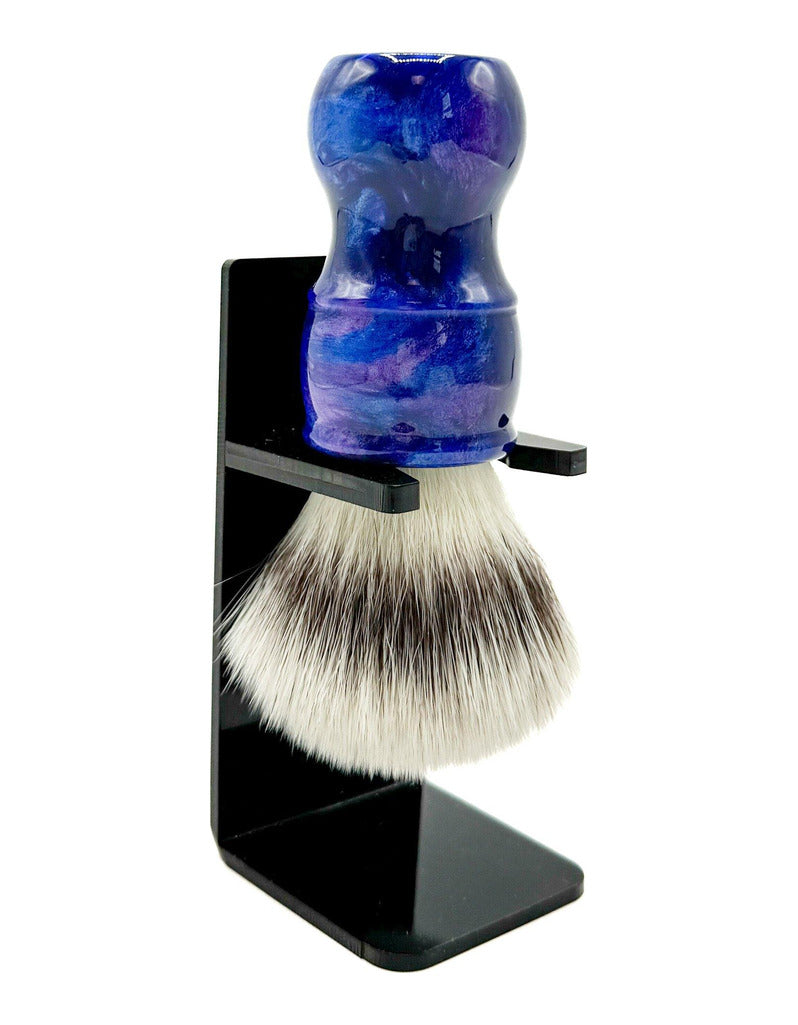 Parker BLSY2 synthetic bristle shaving brush with a swirled blue and purple handle, held upside down in a black drip stand