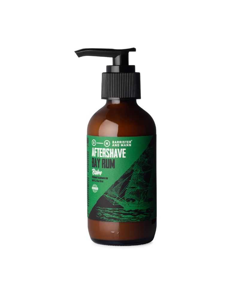 A bottle of Barrister and Mann after shave balm with a pump dispenser, featuring a label with the product name and a graphic of a sailing ship