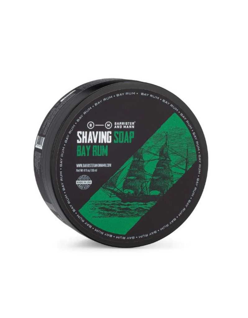 Shaving soap container with green and black design on a white background. Bay Rum Scent from Barrister and Mann