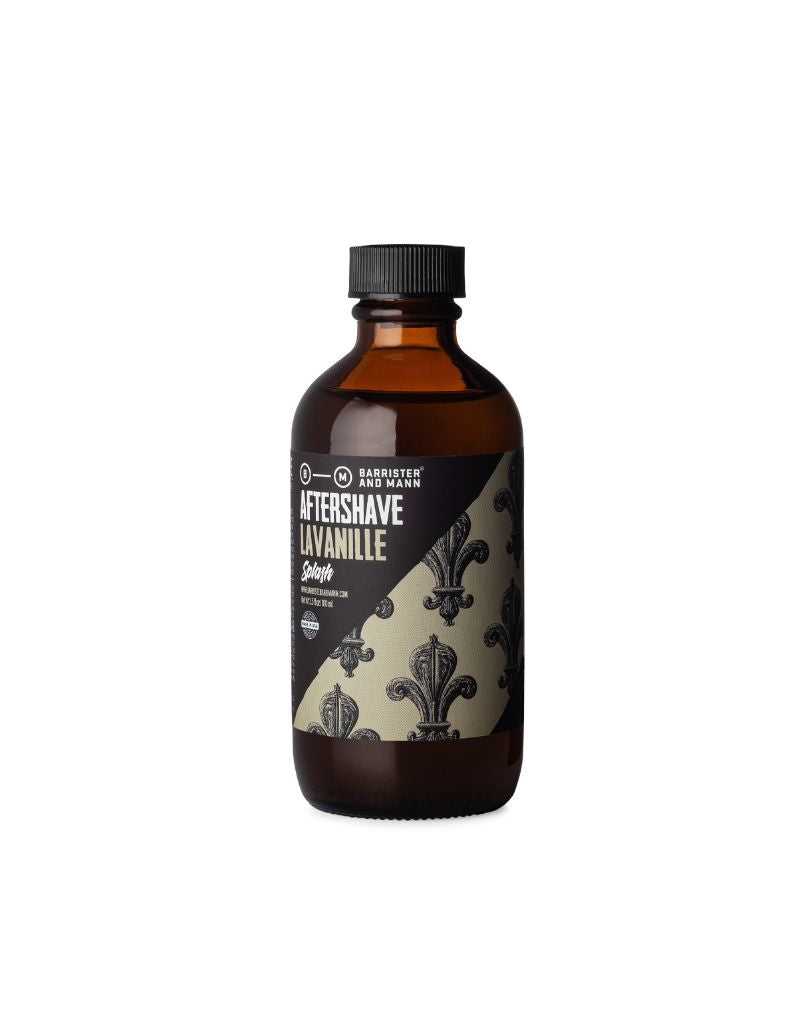 A bottle of Barrister and Mann Lavanille Aftershave Splash with a black and white floral pattern label.