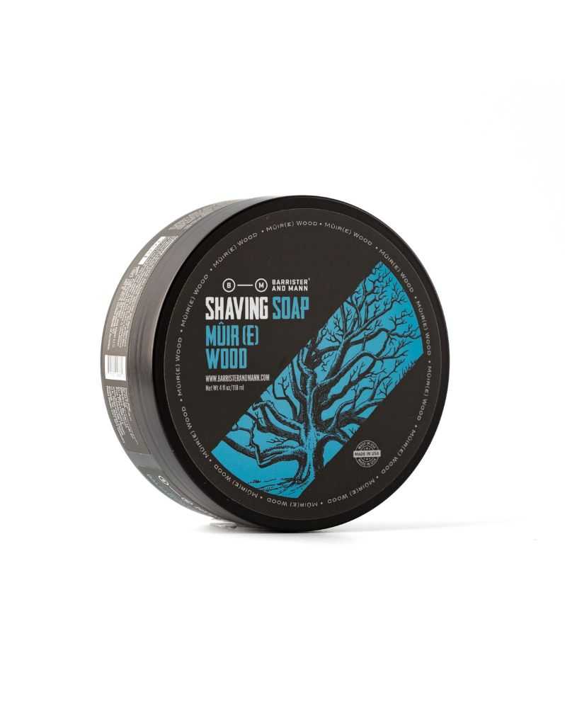 A round container labeled 'SHAVING SOAP MûIR(E) WOOD' with a blue and green tree design.