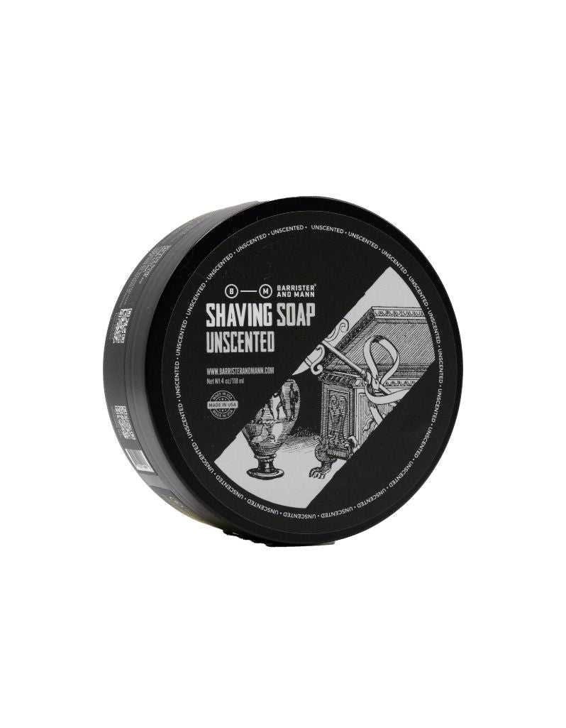 Shaving soap container with black lid and white label on a white background. Unscented by Barrister and Mann.