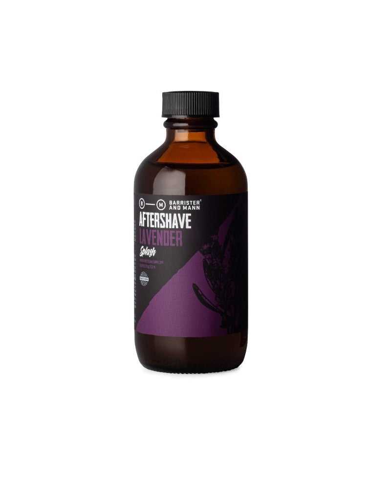 A bottle of Barrister and Mann Lavender Aftershave Splash with purple label detailing product information.