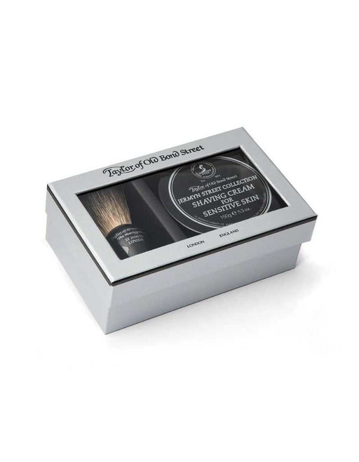 Beard grooming kit with brush and jar in a white box on a white background