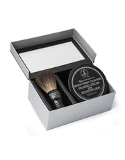 Shaving set with brush and cream in a box on a white background