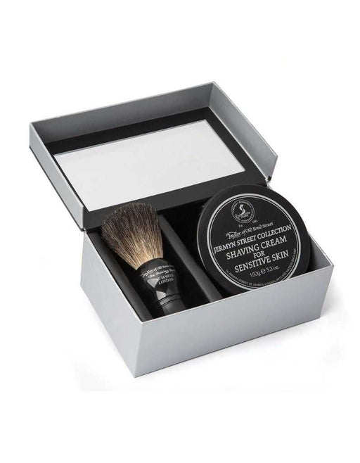 Shaving set with brush and cream in a box on a white background