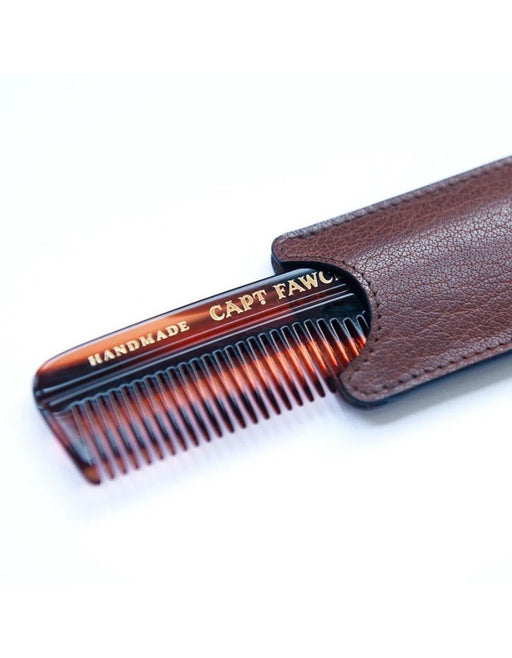 Hair comb with leather case on a white background
