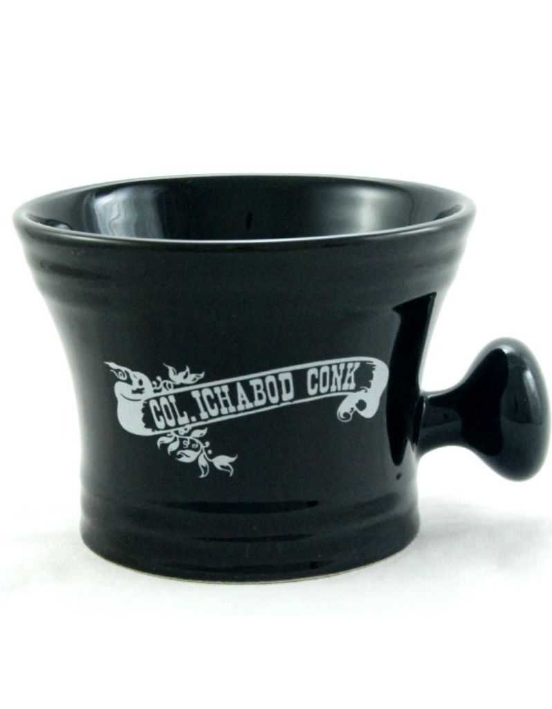Black ceramic apothecary shaving mug with white Colonel Conk logo and knob handle.