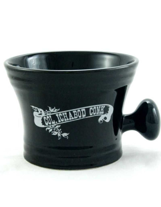 Black ceramic apothecary shaving mug with white Colonel Conk logo and knob handle.