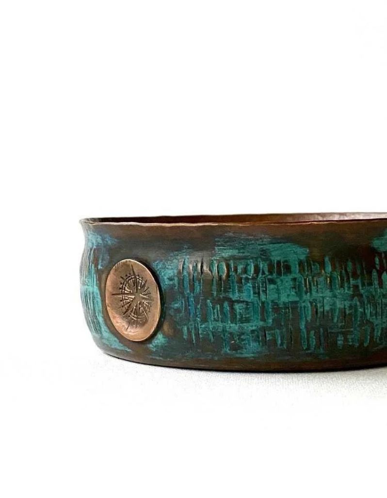 Side view of copper lather bowl showing embossed logo and textured aquamarine exterior, handcrafted from thick copper for grooming