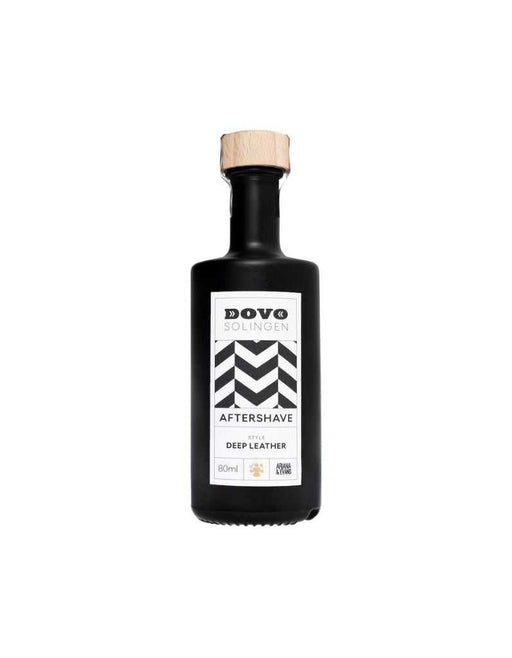 A black bottle with a wooden cap labeled 'DOVO AFTERSHAVE DEEP LEATHER' on a white background.