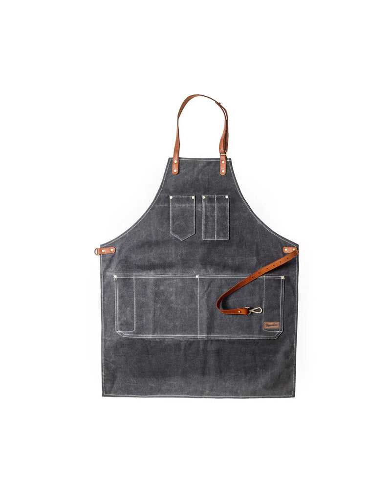 A professional barber's apron in charcoal color with stainless steel metal parts, leather straps, and metal buckles. It features multiple pockets and is displayed in an upright position.