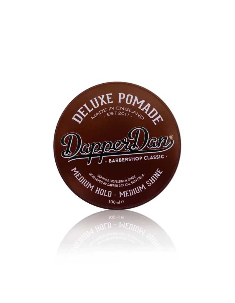 Brown container of Dapper Dan Deluxe Pomade on a white background. Medium hold.