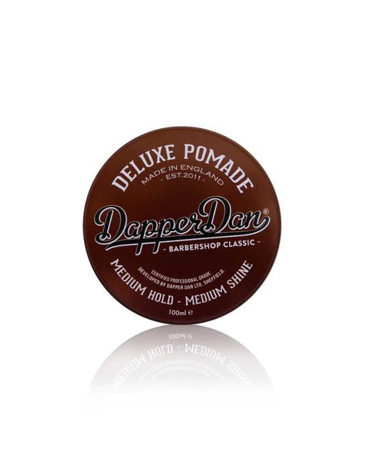 Brown container of Dapper Dan Deluxe Pomade on a white background. Medium hold.
