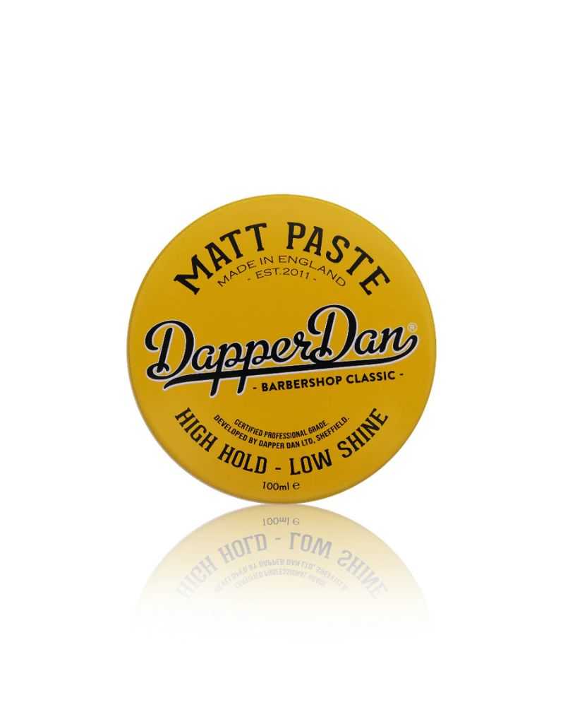 Yellow container of Dapper Dan Matt Paste on a white background