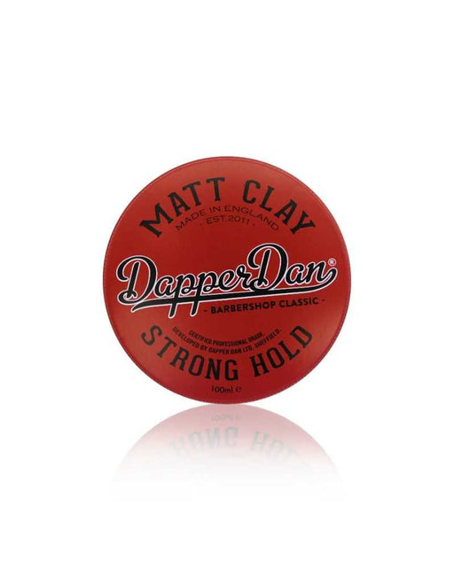 Red round tin of Matt Clay Dapper Dan Strong Hold hair product on a white background