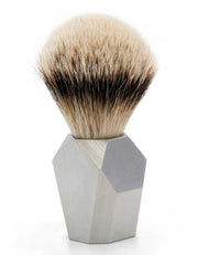 Rex Deco stainless steel shaving brush with natural badger hair bristles, featuring a modern geometric handle with a brushed metal finish on a white background.
