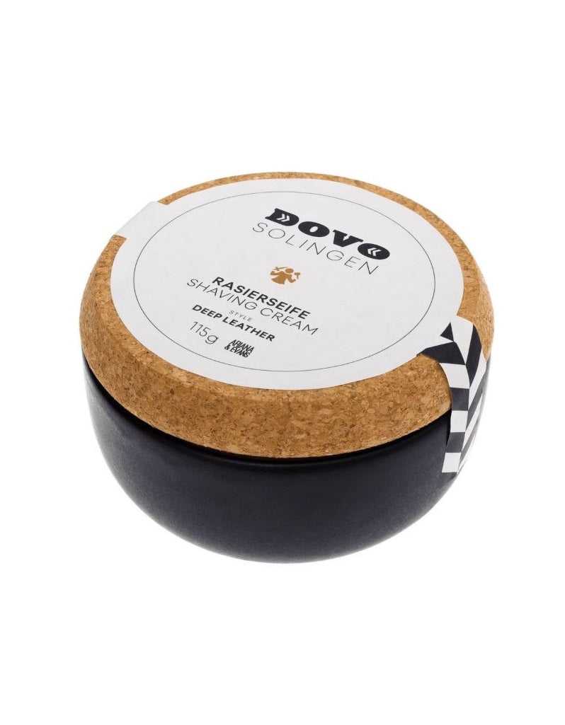 A stoneware container of Dovo shaving cream soap with a cork lid, label visible, on a white background.