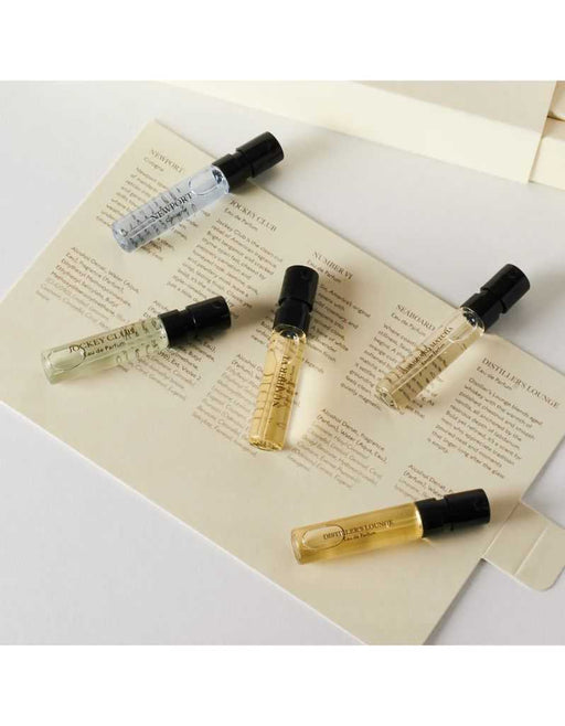 Set of five Caswell Massey Discovery Fragrance Collection sample vials on paper