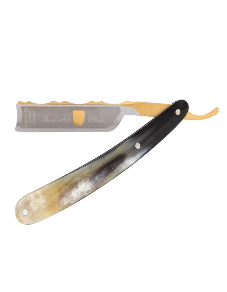 A straight razor with a gold-plated blade and an African cow horn handle. The blade is partially open, showing the gold-plated ornamentation and the horn handle with a unique pattern.