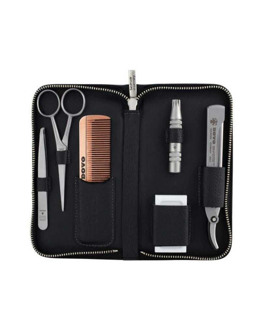 Black grooming kit with various tools including scissors, comb, and knife on a white background