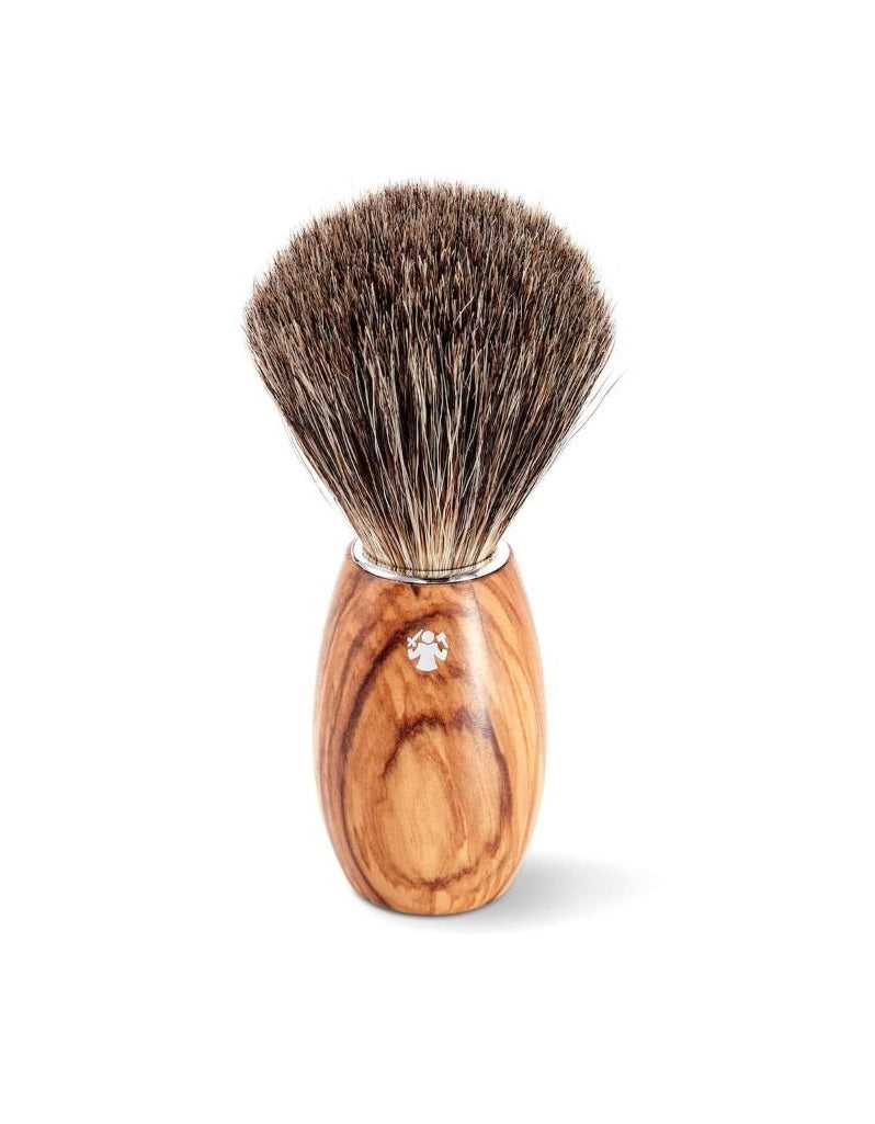 A synthetic badger hair shaving brush with an olive wood handle, displayed upright on a white background.
