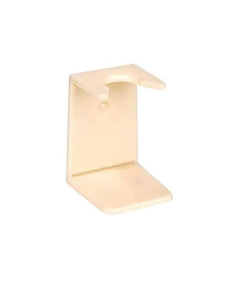 A small, beige, imitation ivory shaving brush stand with a central opening and a flat base.