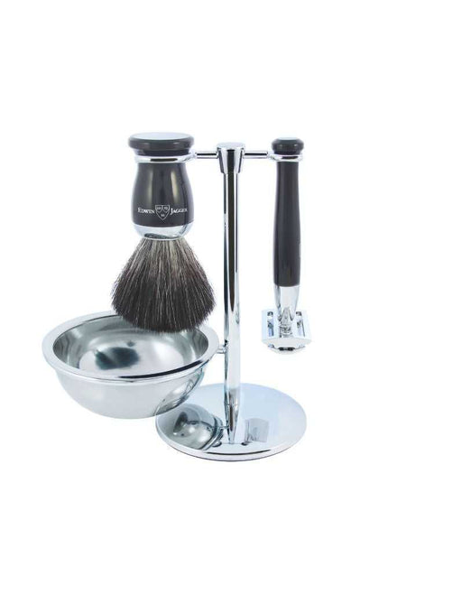 A luxury shaving set including a shaving brush, a safety razor, and a metal shaving bowl, all displayed on a chrome stand.