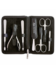 A 7-piece manicure set with tools including scissors, tweezers, a nail file, cleaner, cuticle pusher, and clippers, neatly arranged inside a black leather case with a water buffalo texture.
