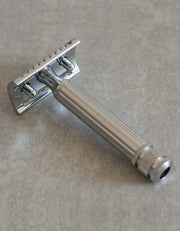 Back view of the Fatip Classic chrome razor showing the baseplate and fluted handle on a gray stone surface