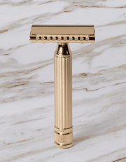 Fatip l’Ibrido Classic gold safety razor rotating to show both sides of its hybrid open and closed comb head