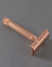 Fatip il Grande Gentle safety razor in copper with a fluted handle and knurled end cap, on a gray background
