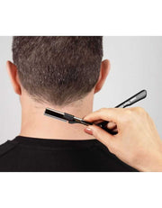 Person using a nape razor on their neck against a plain background