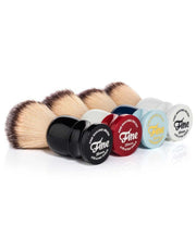 Fine Classic shaving brushes lying side by side in black, red, navy, light blue and white handles