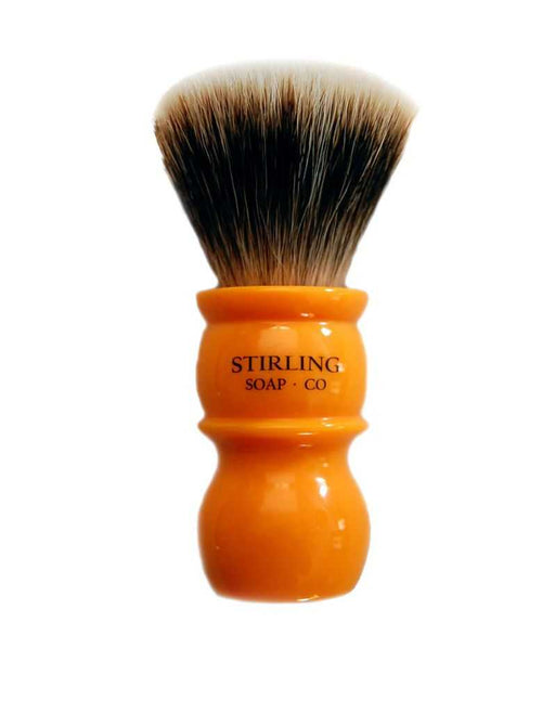Stirling Shaving brush with orange handle and black badger bristles on a white background