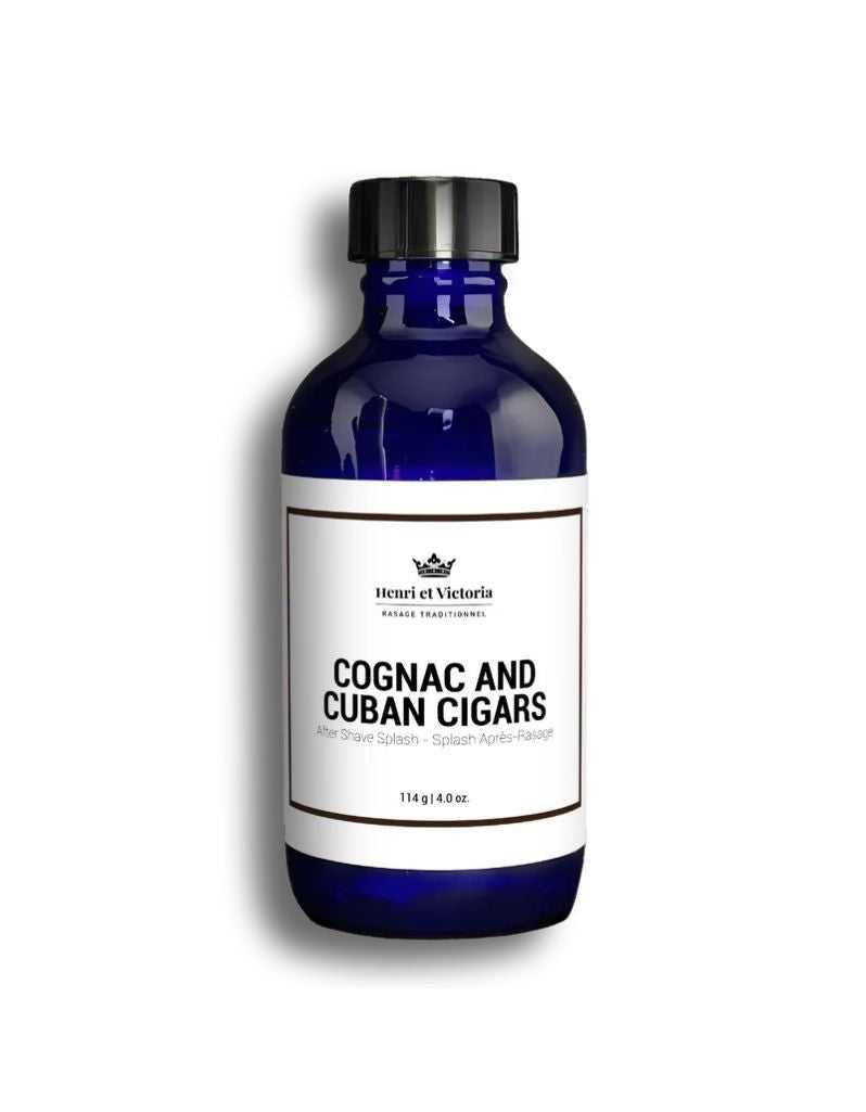 A blue bottle labeled 'Henri Et Victoria Cognac and Cuban Cigars Aftershave Splash', with a capacity of 114ml.
