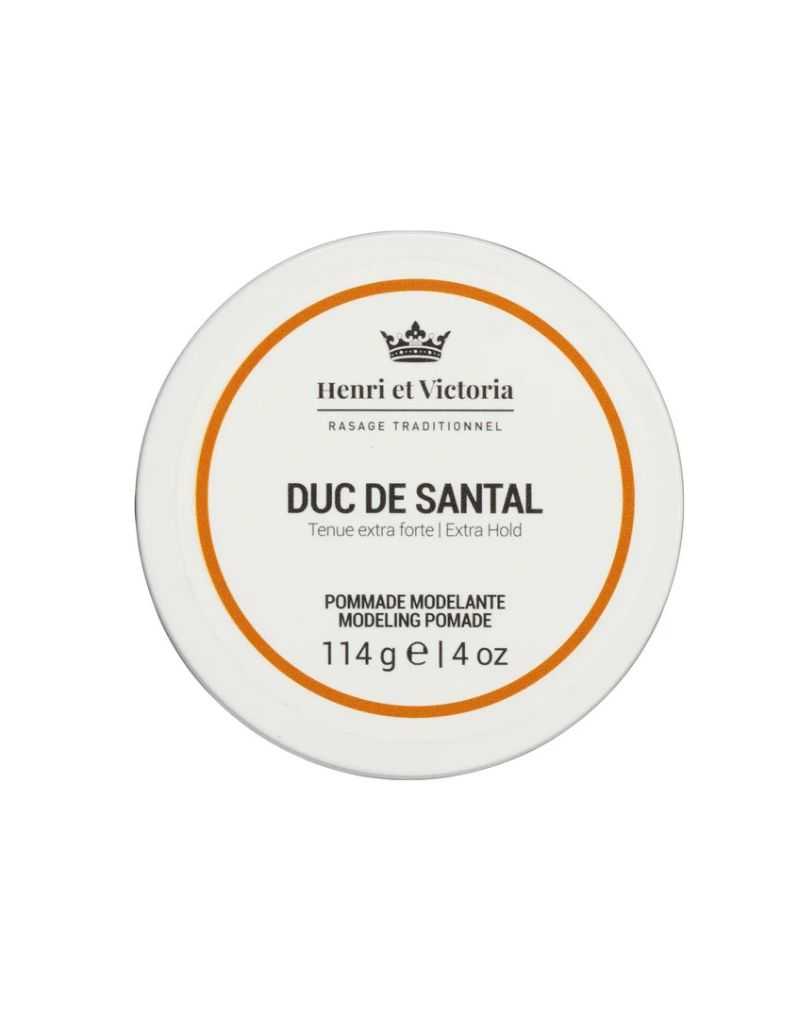 A container of Henri Et Victoria Duc de Santal Pomade with white and orange label, 114g size.