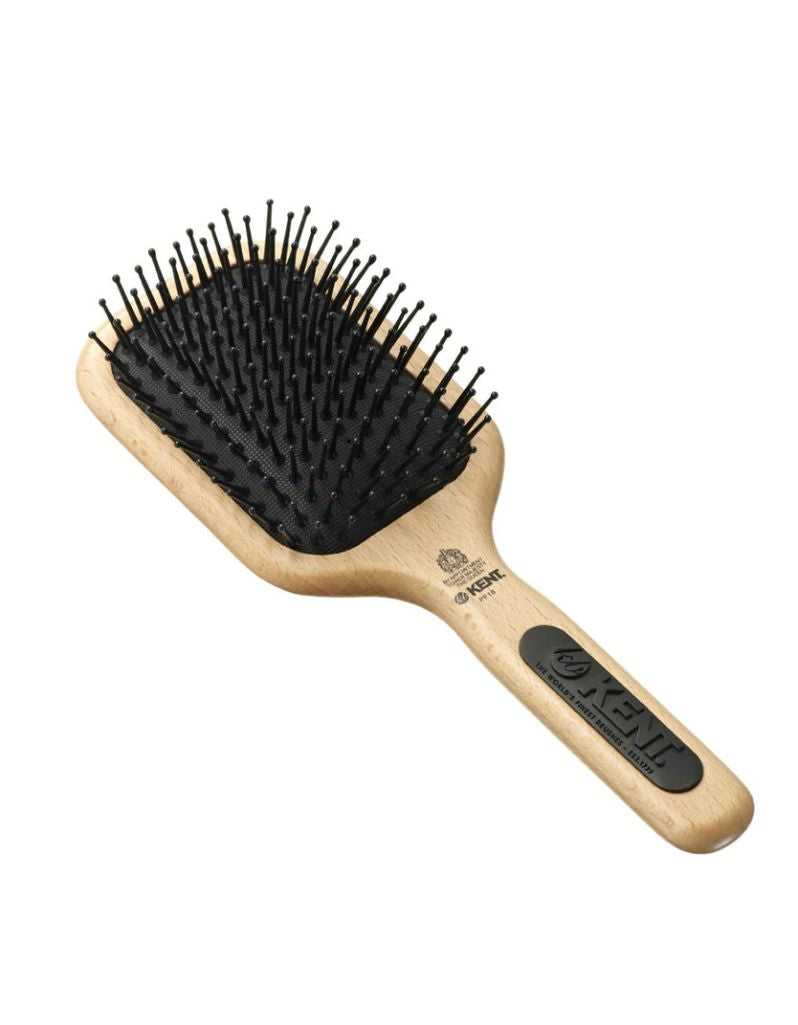 Hairbrush with black bristles and wooden handle on a white background
