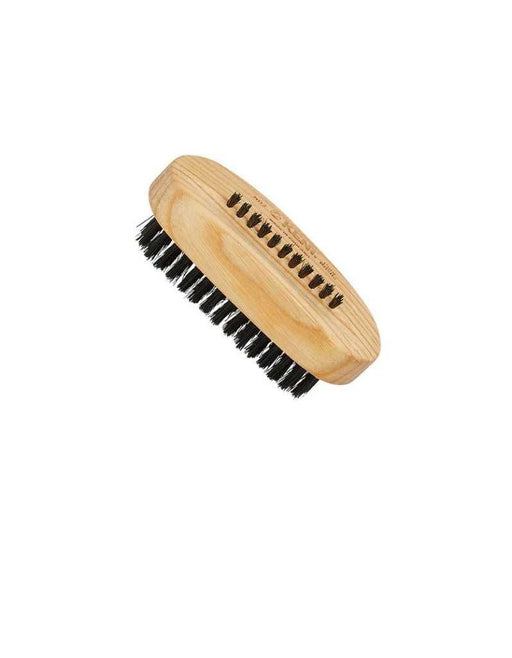 A wooden nail brush with black bristles and an additional row of bristles on the back.