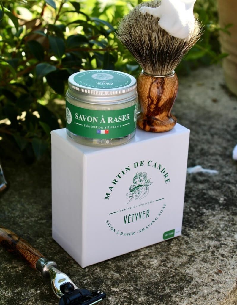 Artisan Vetiver shaving soap with brush and razor outdoors in a travel jar