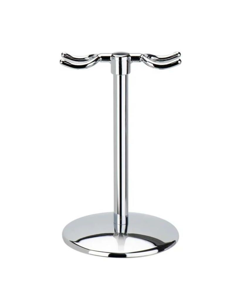 A bright chrome finish razor stand with a round base and two dedicated hooks for holding a razor and brush.
