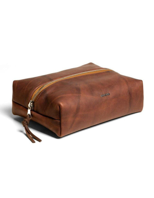 Brown leather toiletry bag with zipper on a white background