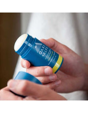 Open Oars + Alps California Coast deodorant stick in hand, showing white product inside