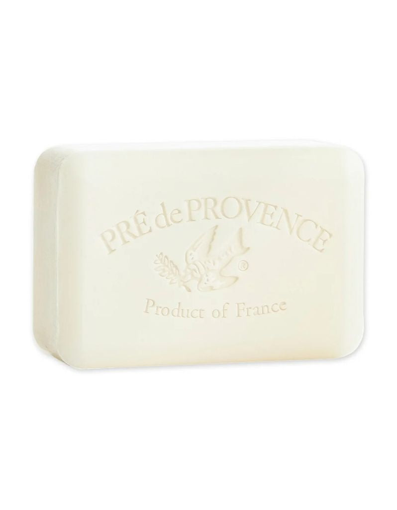 A rectangular bar of Pré de Provence soap in a warm cream color, embossed with the brand name and a bird logo, set against a plain white background.